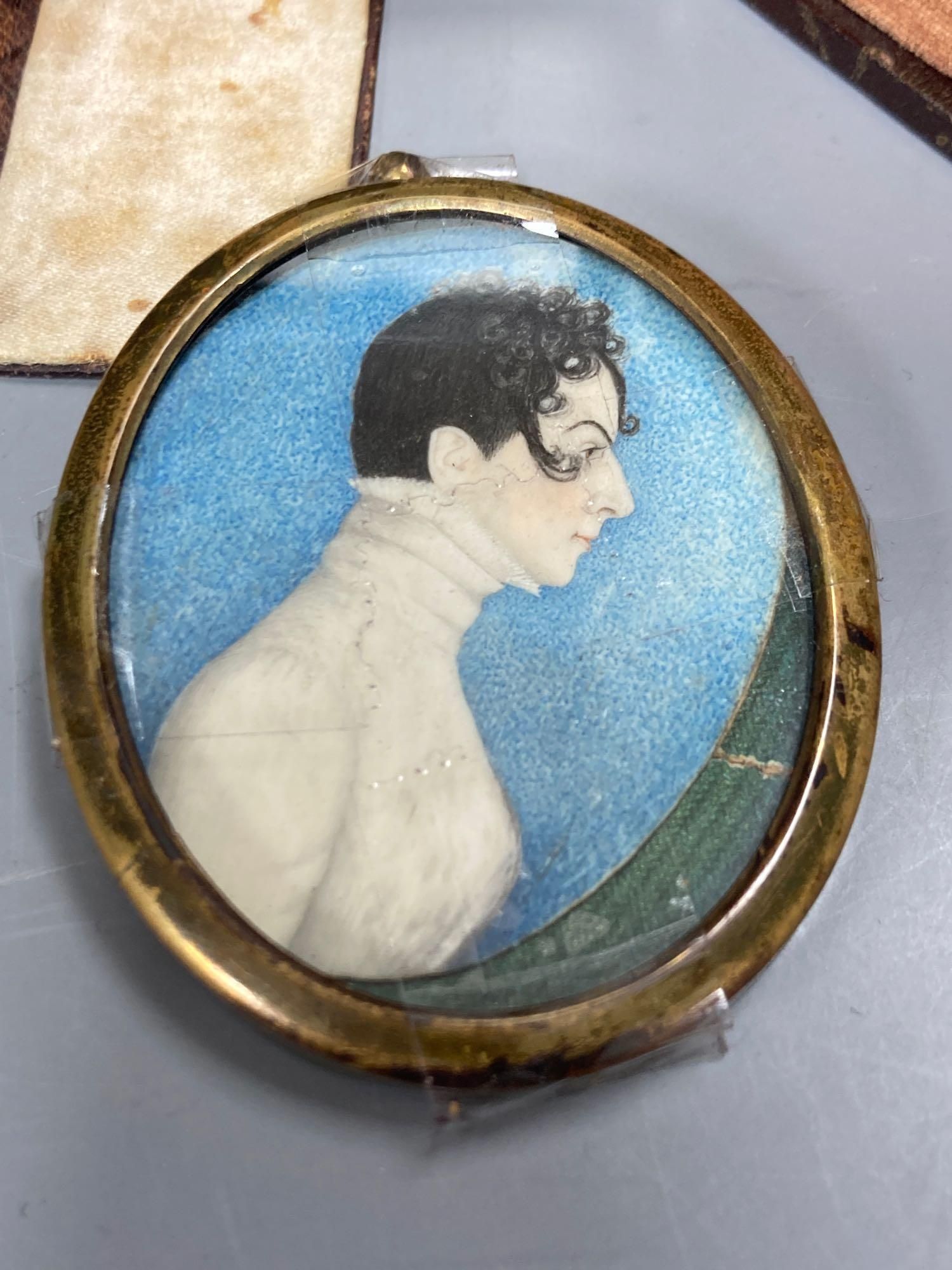 Five assorted miniatures of gentleman including one in yellow metal frame, largest being an oval portrait in a brown velvet frame, 5cm